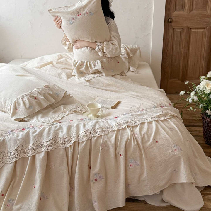 Country house style complete bedding set with voluminous bed skirt, lace trim, and fine floral embroidery