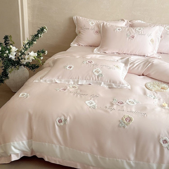 Luxurious satin bedding set with embroidered rose appliqués and silky glossy finish