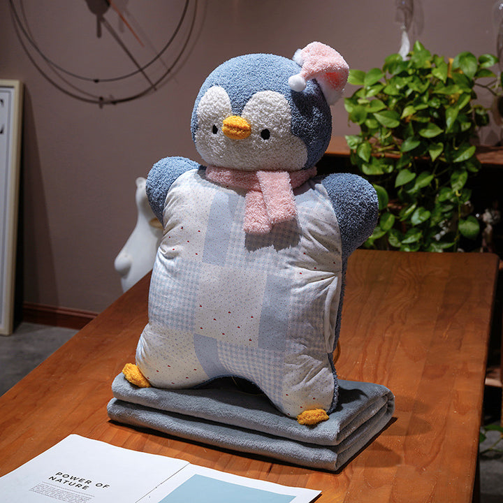 Cozy plush pillow with integrated blanket in penguin look