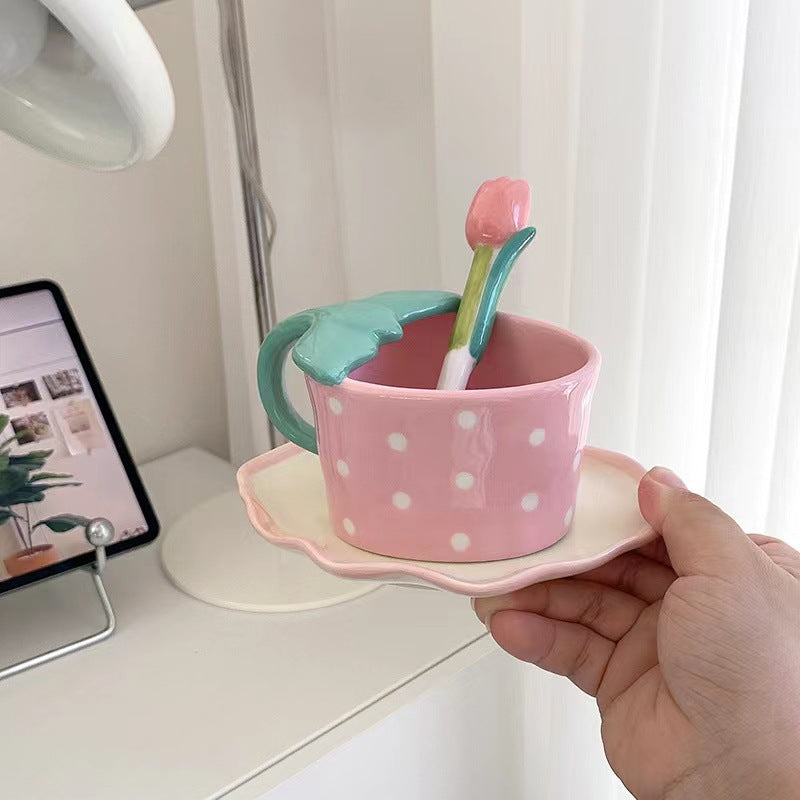 Playful ceramic mug with shaped leaf handle, saucer, and tulip spoon