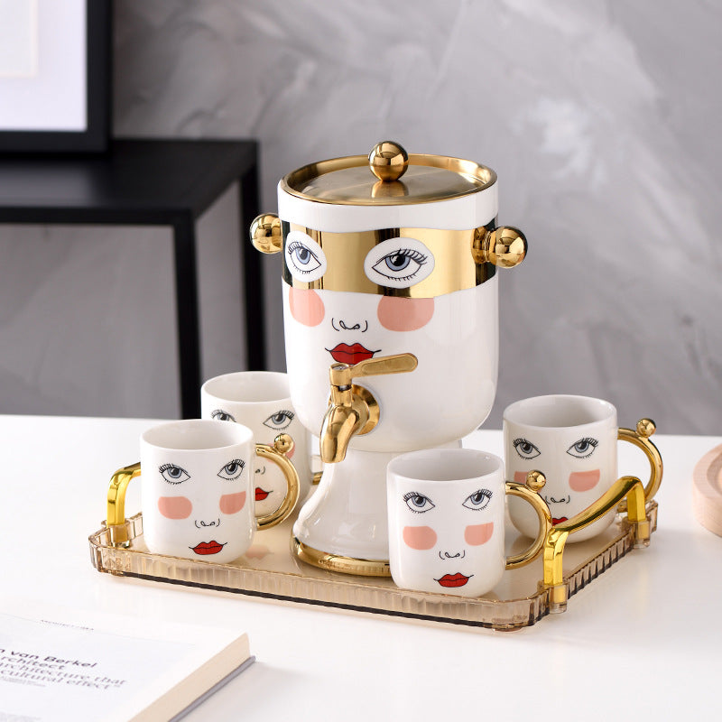 Decorative ceramic beverage dispenser with tap, hand-painted face and gold-finished lid