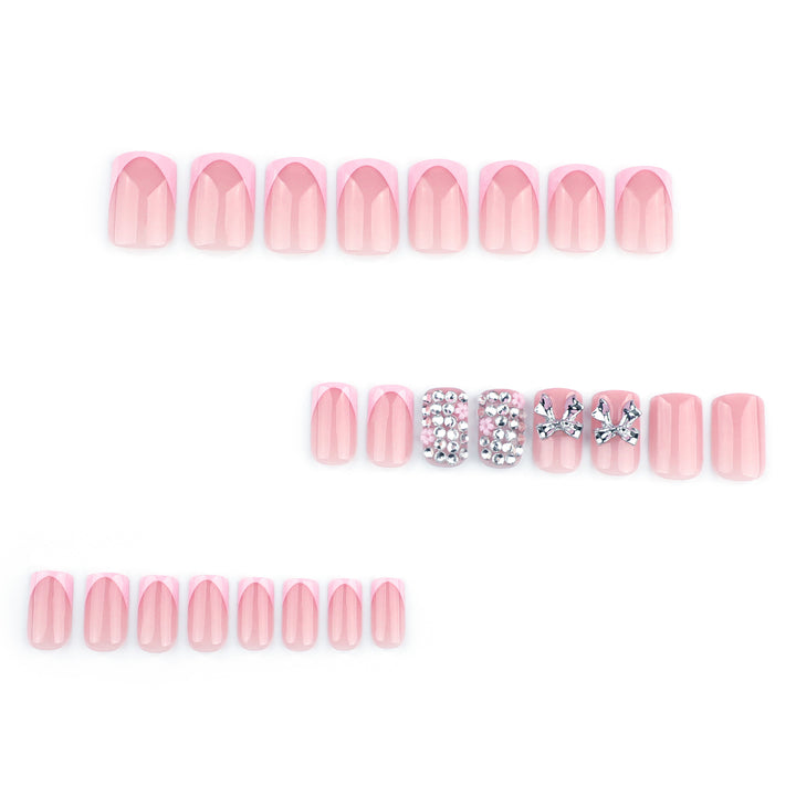 Artful nail art with glitter accents and bow decoration Kalsten