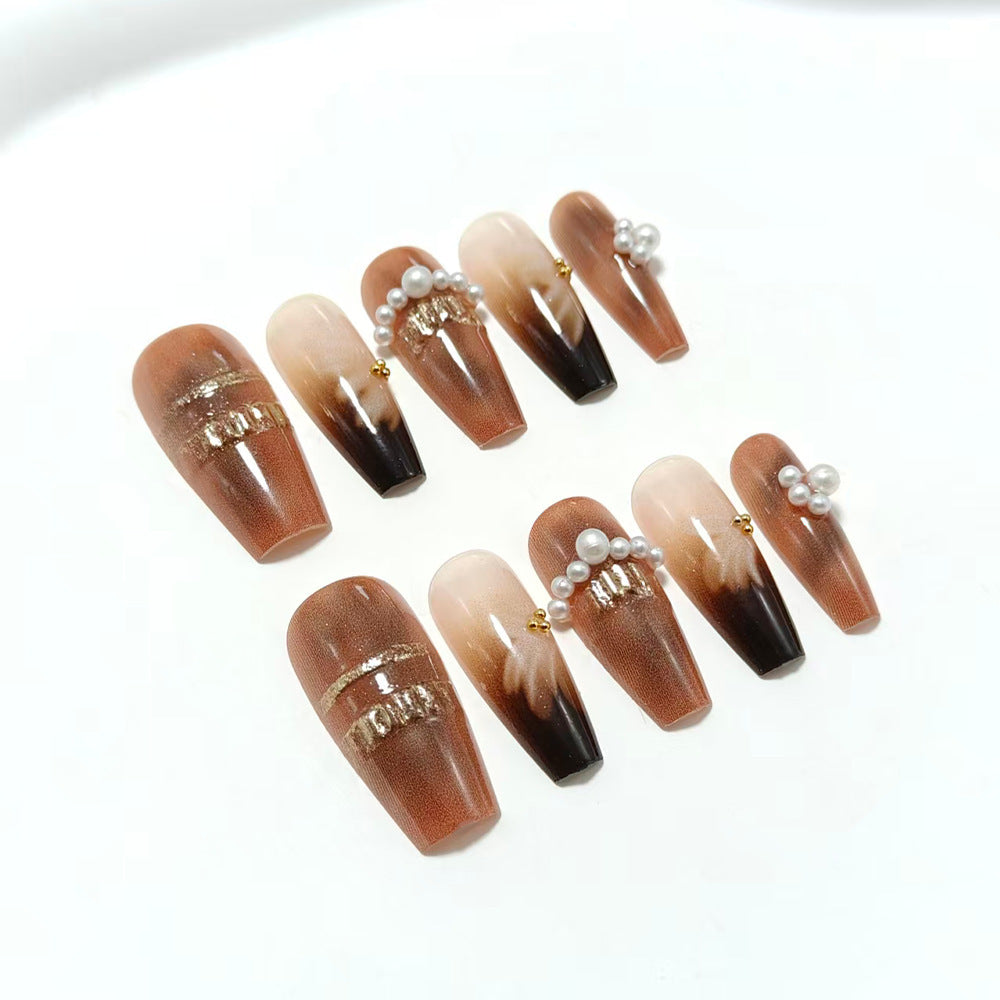 Artificial nails with glamorous gold and pearl embellished accents Kalsten