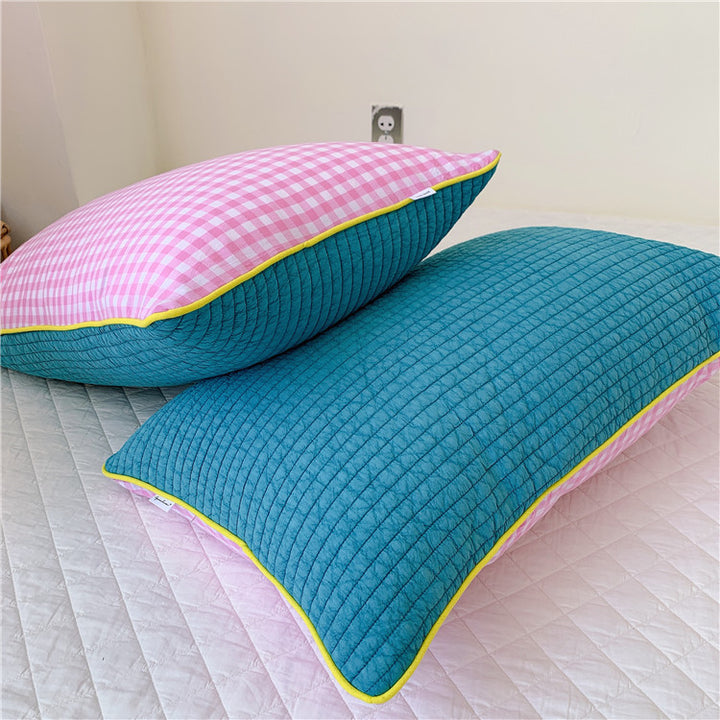 Reversible quilted pillow set with checked cotton cover and contrasting piping