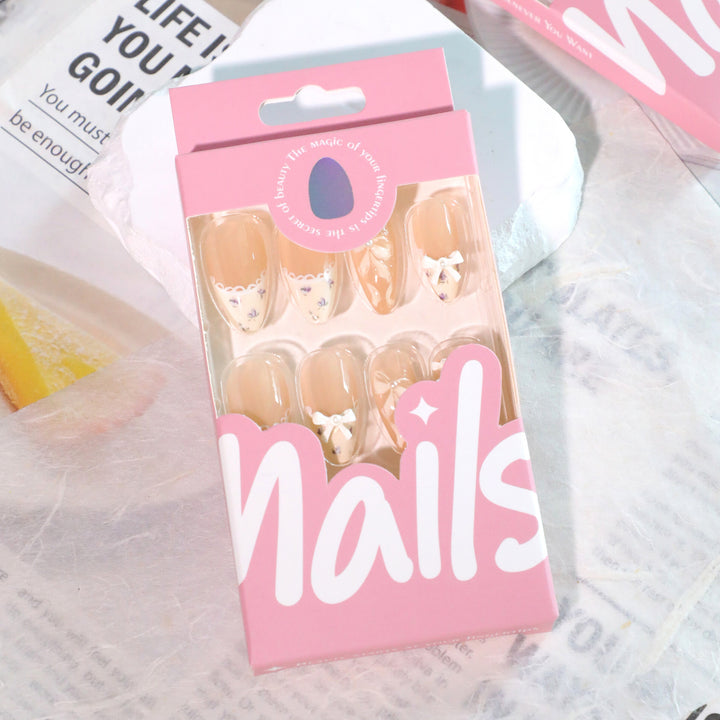 Artful nail art with elegant bows and rhinestone details Kalsten