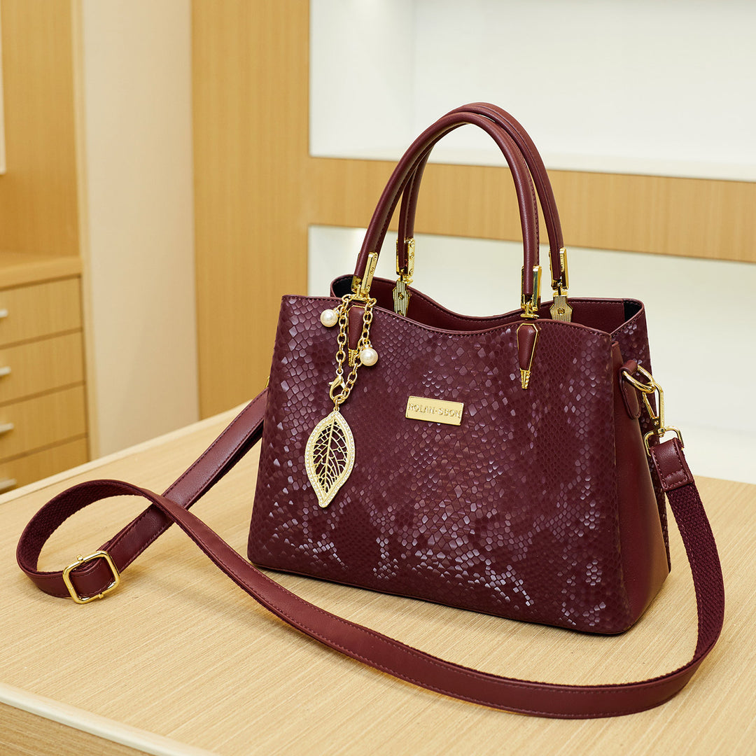 Elegant Designer Handbag with Decorative Charm