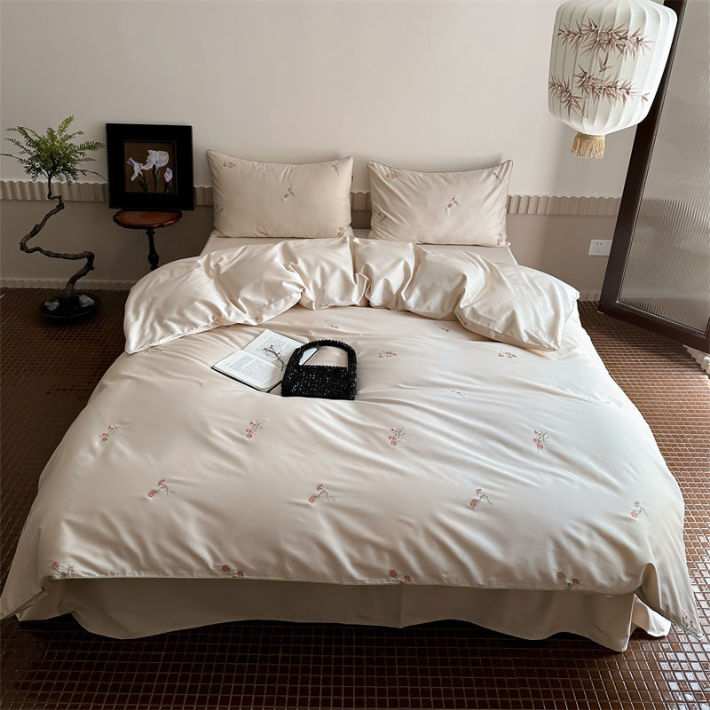 Luxurious cotton satin bedding set with delicate floral embroidery and a silky-matte surface