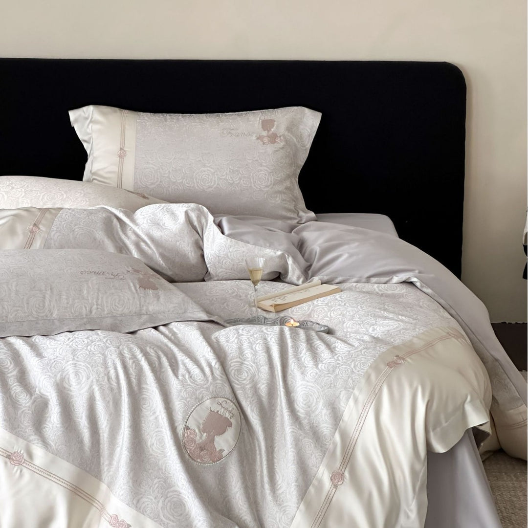 Luxurious cotton satin bed linen set with jacquard rose pattern and embroidered silhouette applications