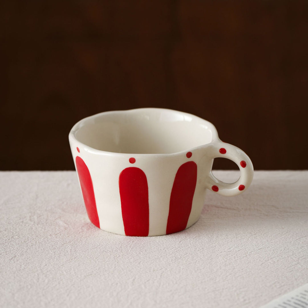 Handmade ceramic mug with ergonomic handle and wavy rim