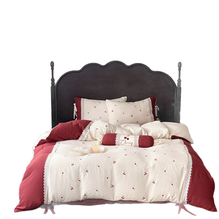 Country-style bedding set with cherry embroidery, lace trim, and decorative neck roll