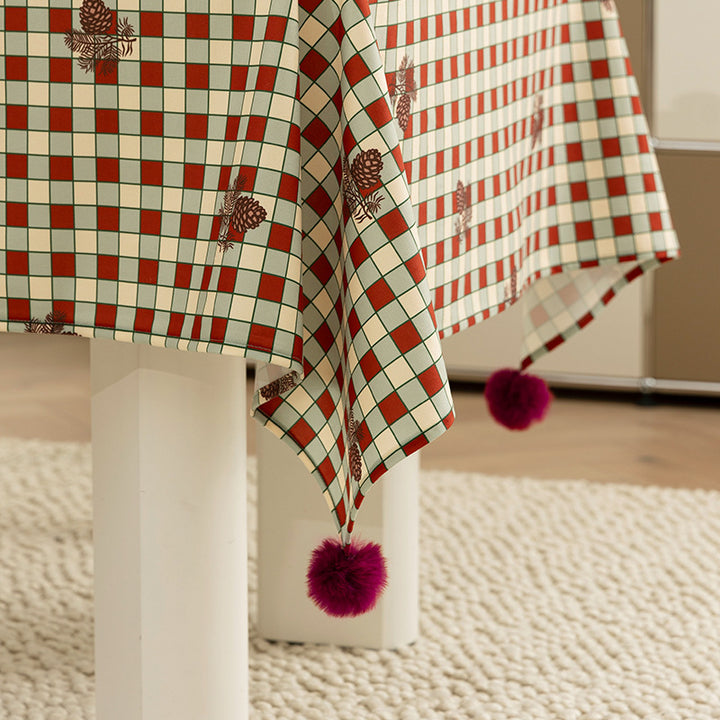Checked flannel tablecloth with pom-pom tassels and traditional tartan pattern