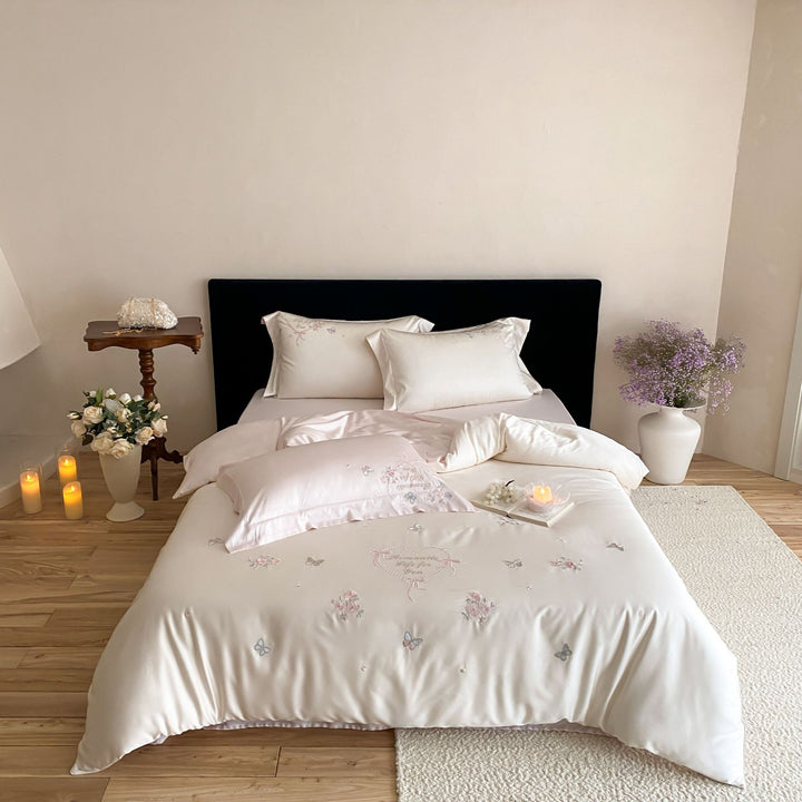 Luxurious embroidered cotton satin bedding set with delicate butterfly and flower appliqués