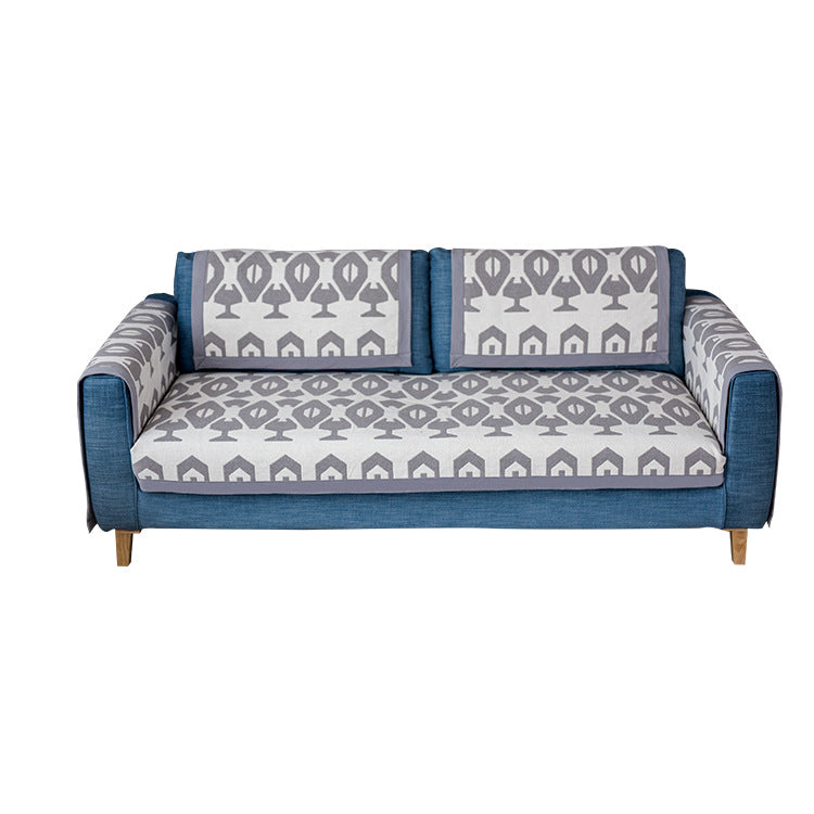 Universal sofa protective cover for three-seater with leaf print, non-slip underside and separate armrest covers Kalsten