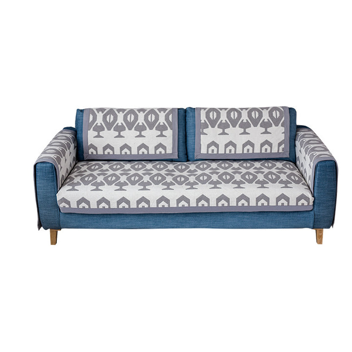 Universal sofa protective cover for three-seater with leaf print, non-slip underside and separate armrest covers Kalsten