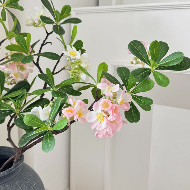 Artificial flower branch with fine pink flowers and vibrant leaves