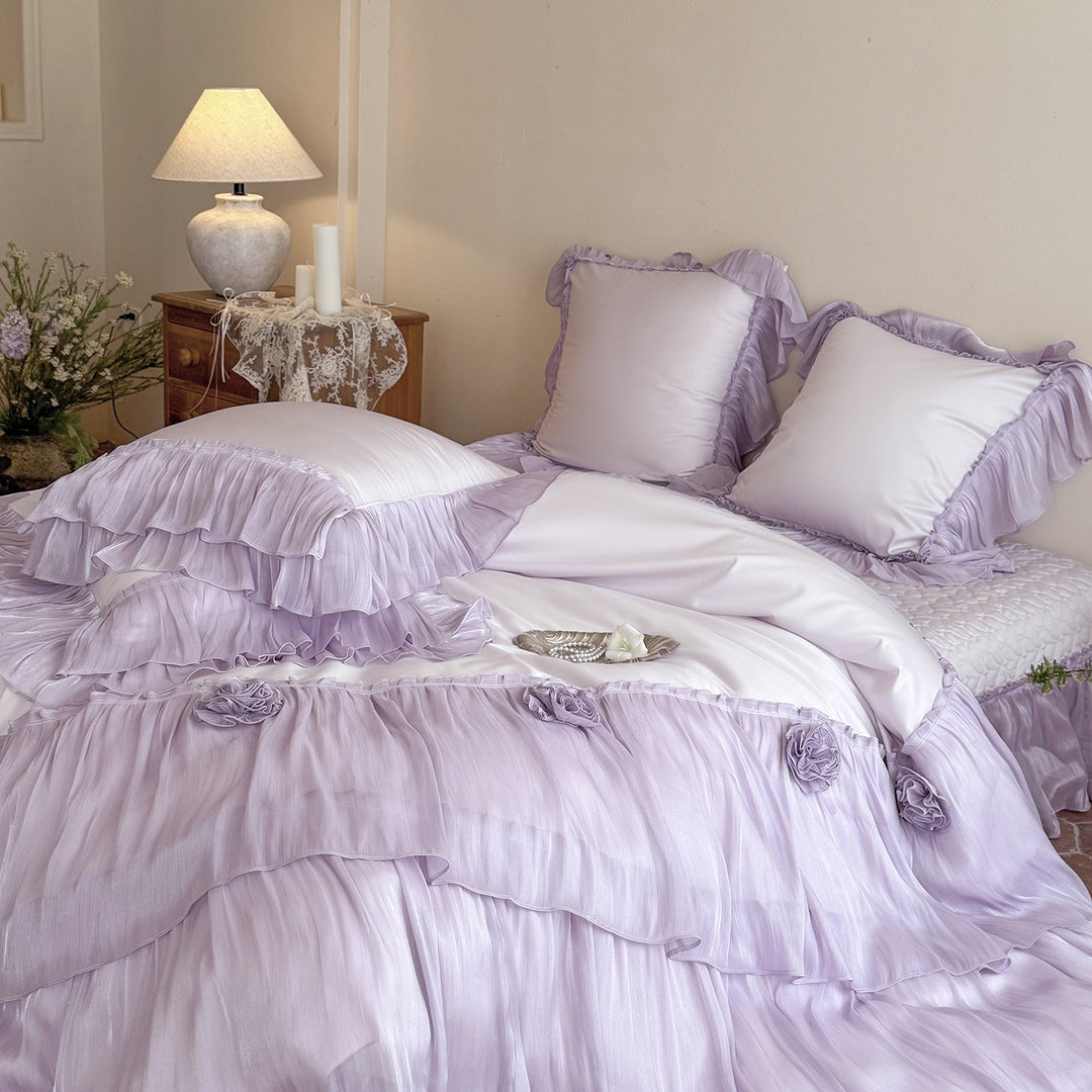 Romantic satin bedding set with layered ruffles and rose appliqués