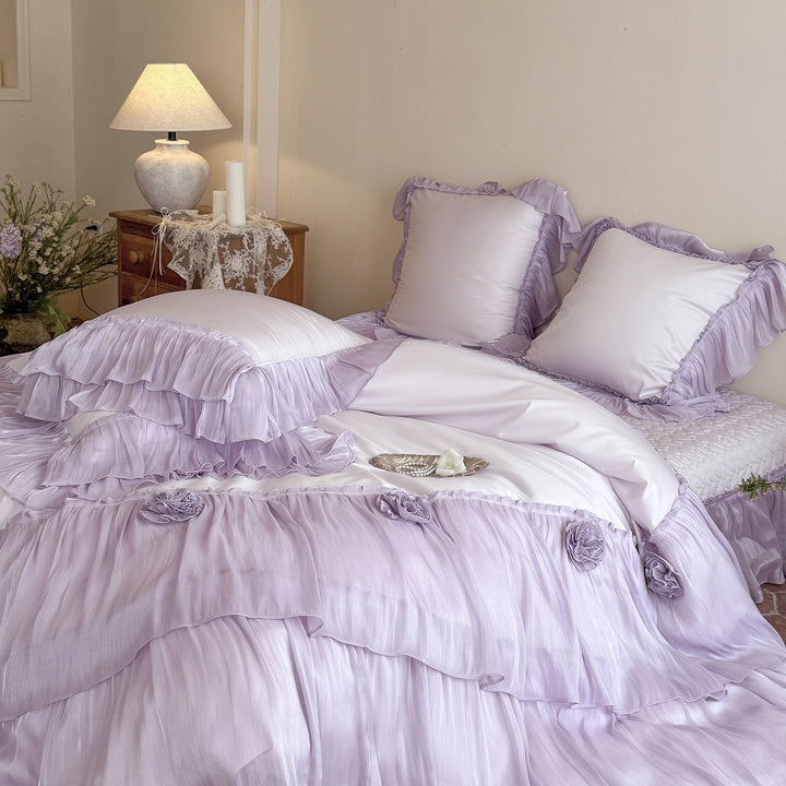 Romantic satin bedding set with layered ruffles and rose appliqués