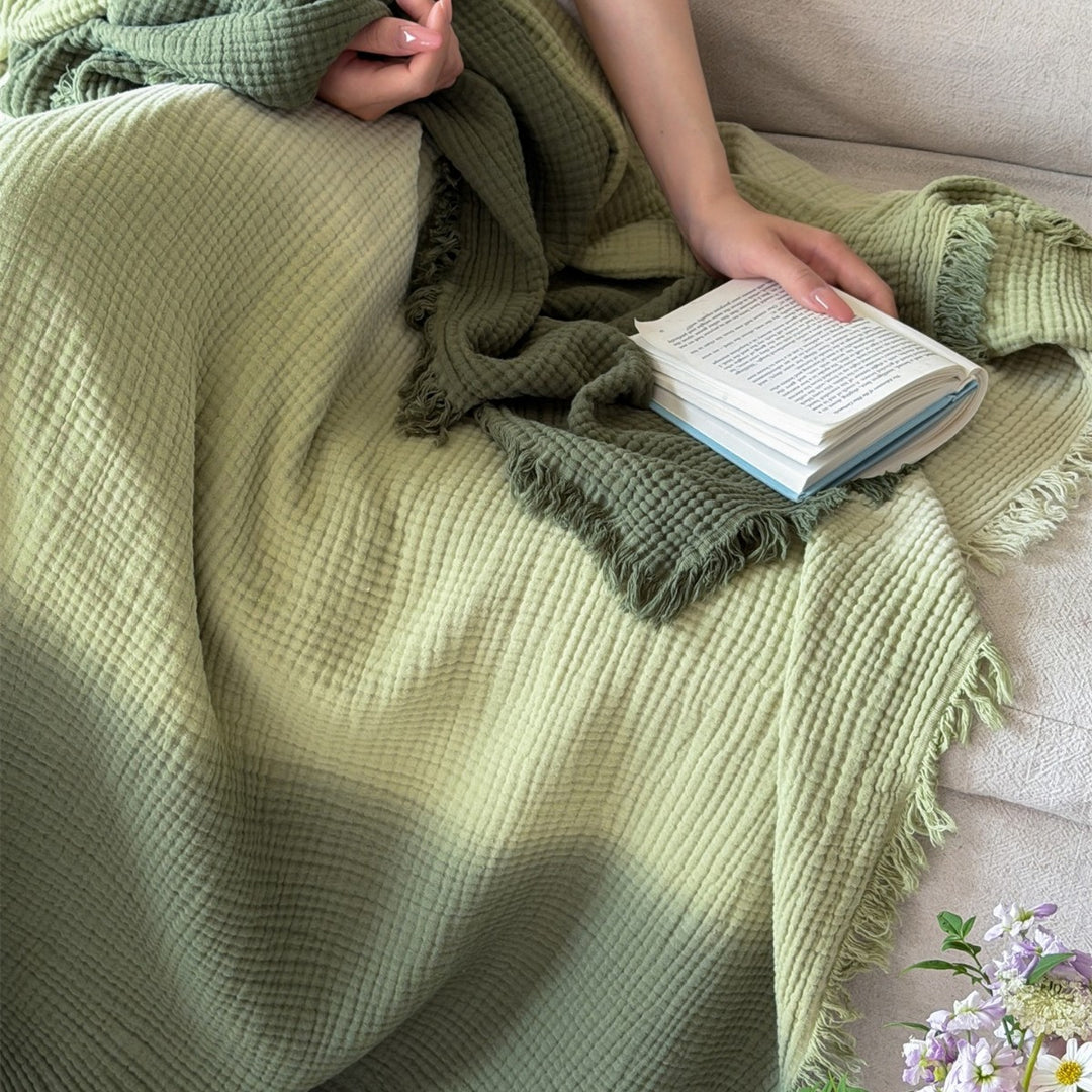Large waffle blanket with ombre coloring and decorative fringes