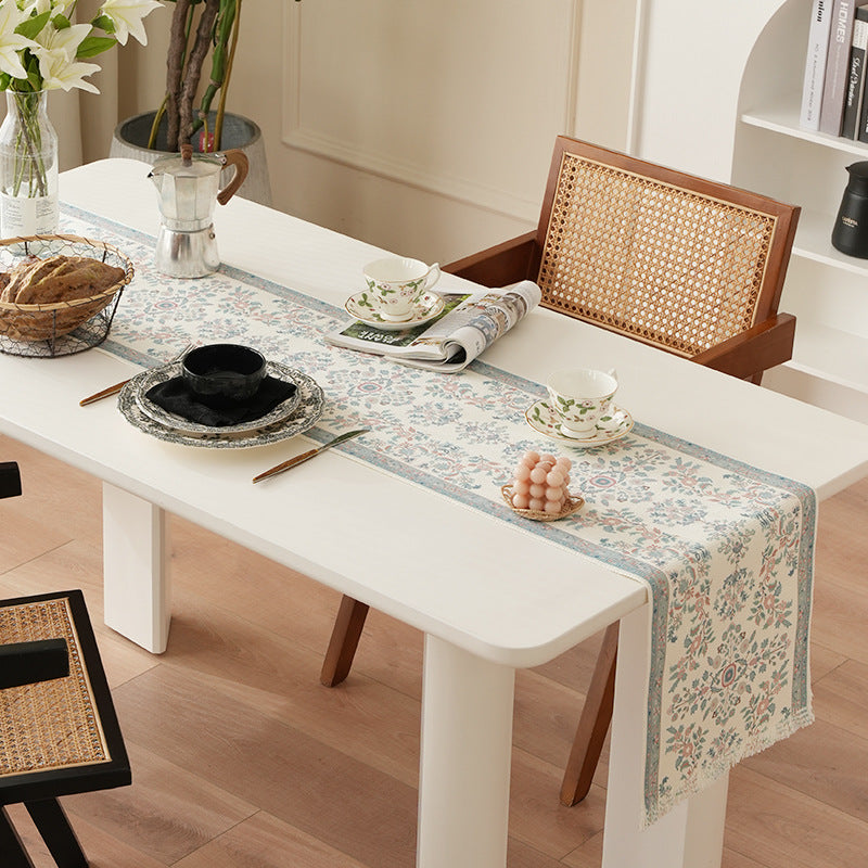 Jacquard table runner with floral border pattern and fringes