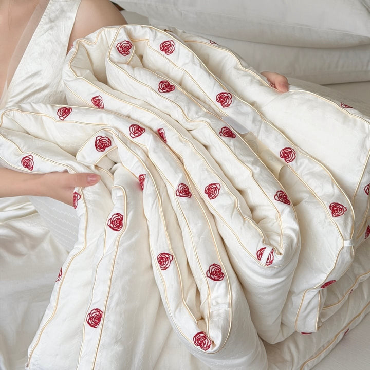 Quilt made of cotton satin with embroidered rose trim