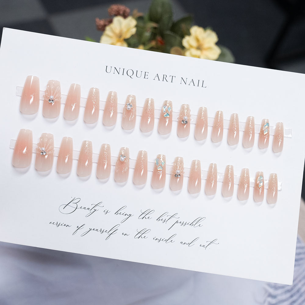 Decorative Press-On Nail Art with Pearl Accents and Shell Design