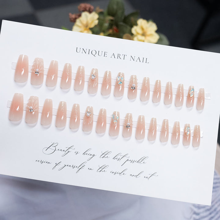 Decorative Press-On Nail Art with Pearl Accents and Shell Design