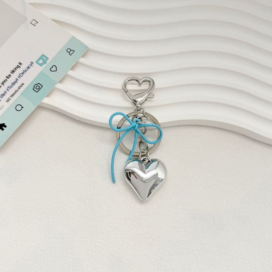 Heart-Shaped Metallic Keychain with Decorative Bow Kalsten