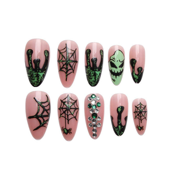 Acrylic nails with Halloween spider design and glitter accents Kalsten