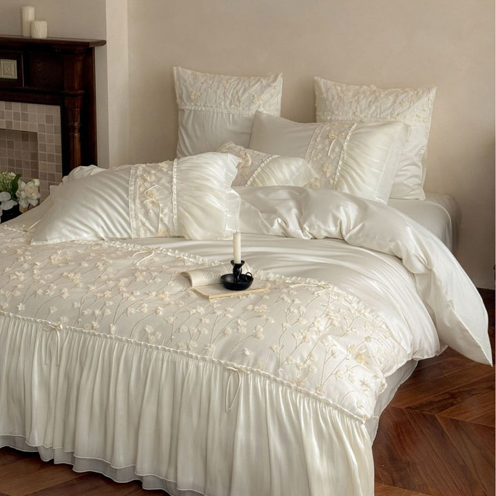 Embroidered bedding set with ruffles and three-dimensional flower appliqués