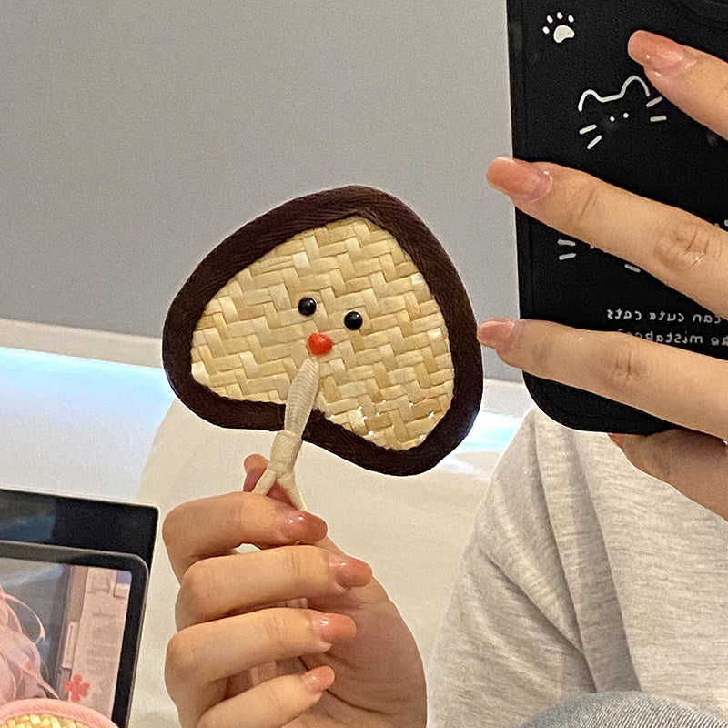 Handcrafted fan with playful face motif Kalsten