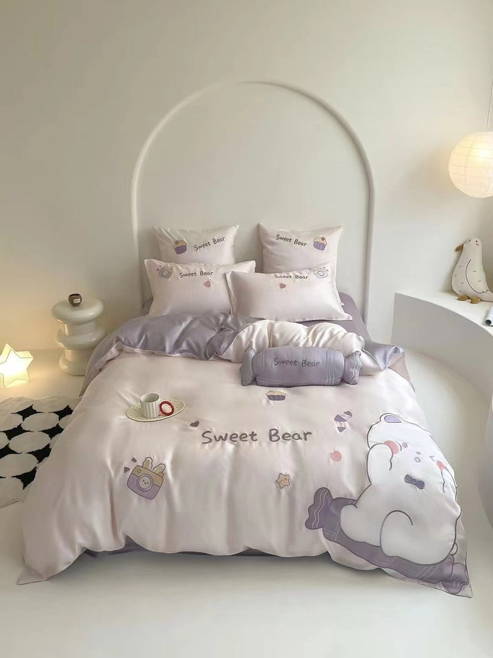 Children's bedding set with embroidered doll appliqués, ruffle and cuddle pillow