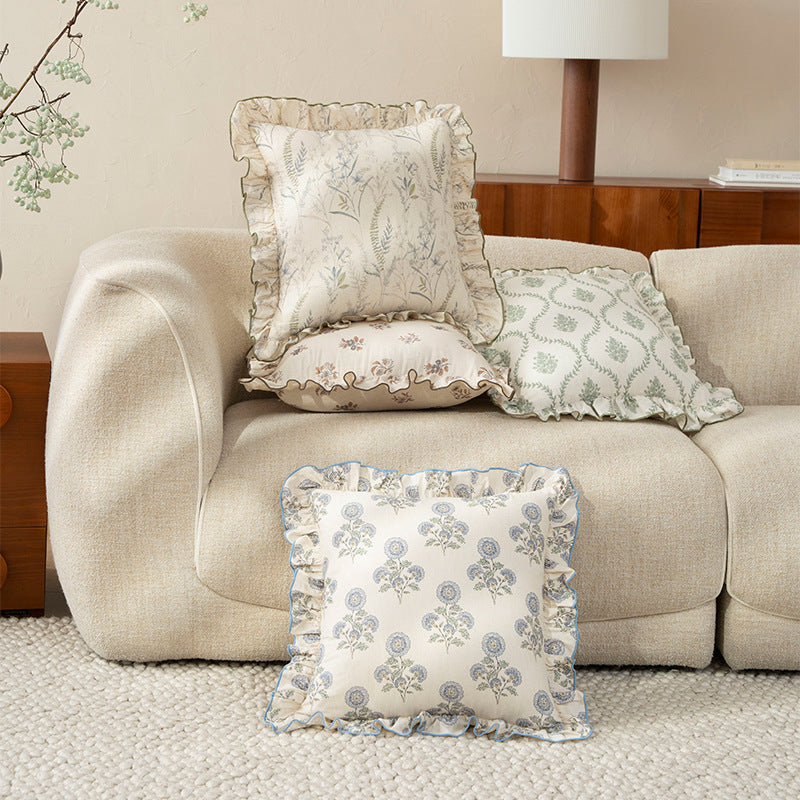 Decorative pillow with ruffles and floral linen cover