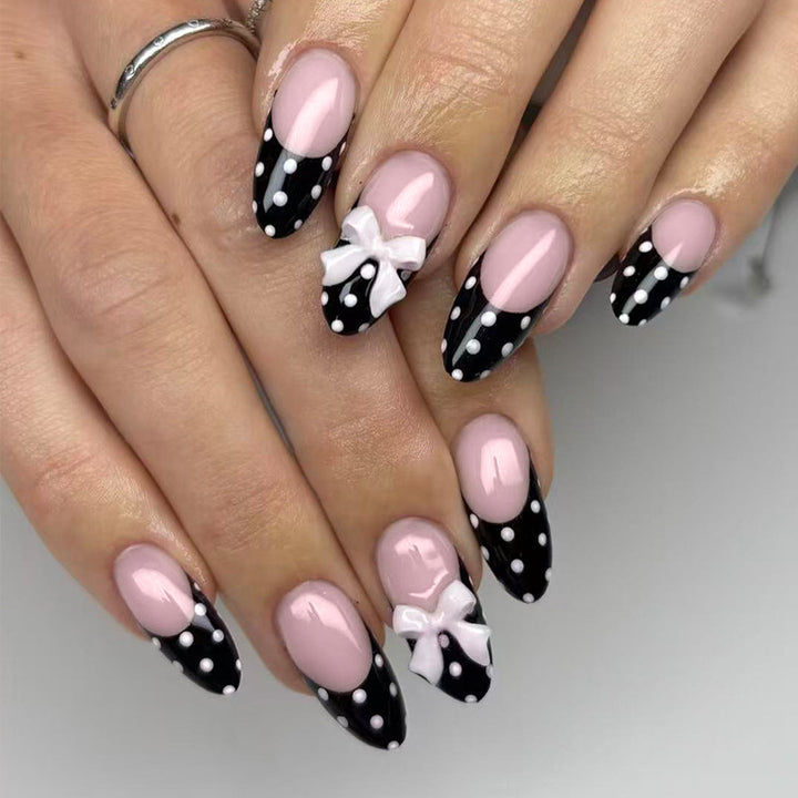 Artificial nail set with glamorous black and white polka dot accents Kalsten