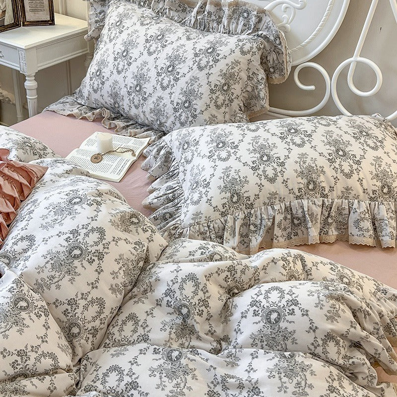 Romantic quilted comforter with ruffled border and fine floral pattern