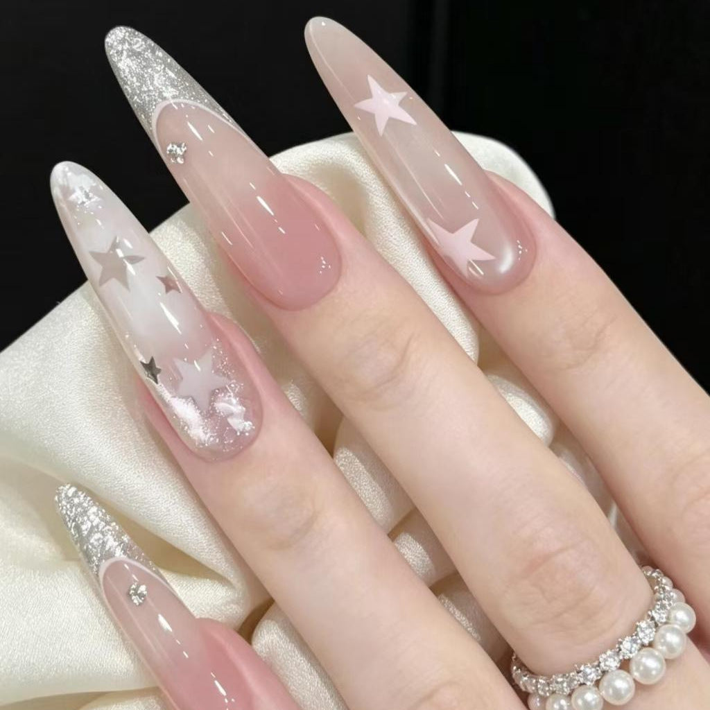 Stiletto Nail Enhancements with Glitter and Star Accents