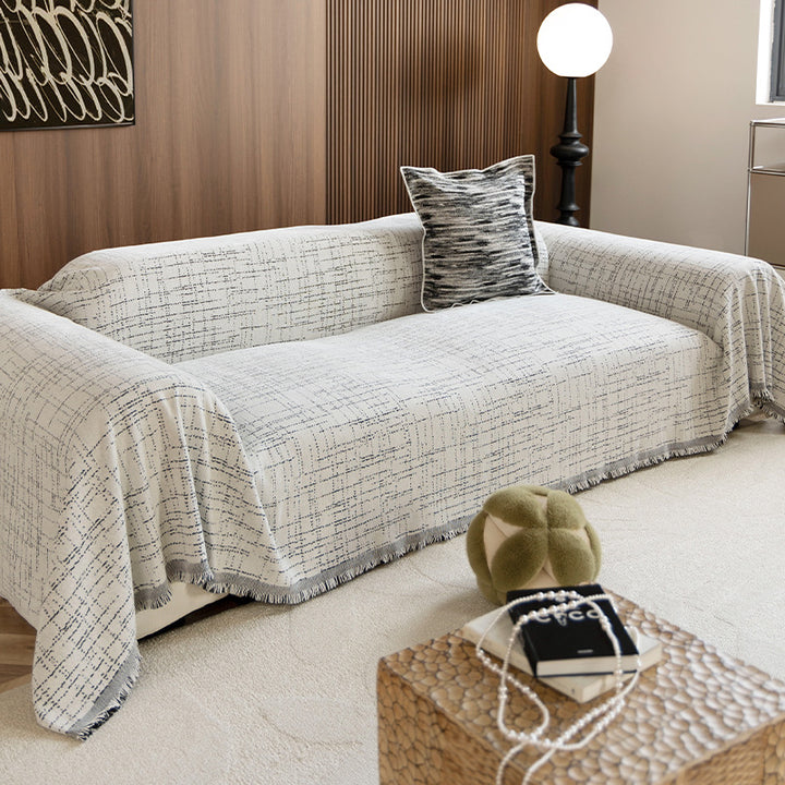 Universal three-seater protection cover made of woven cotton blend with fringes