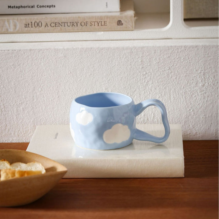 Ceramic mug with hand-painted stripes and flower design