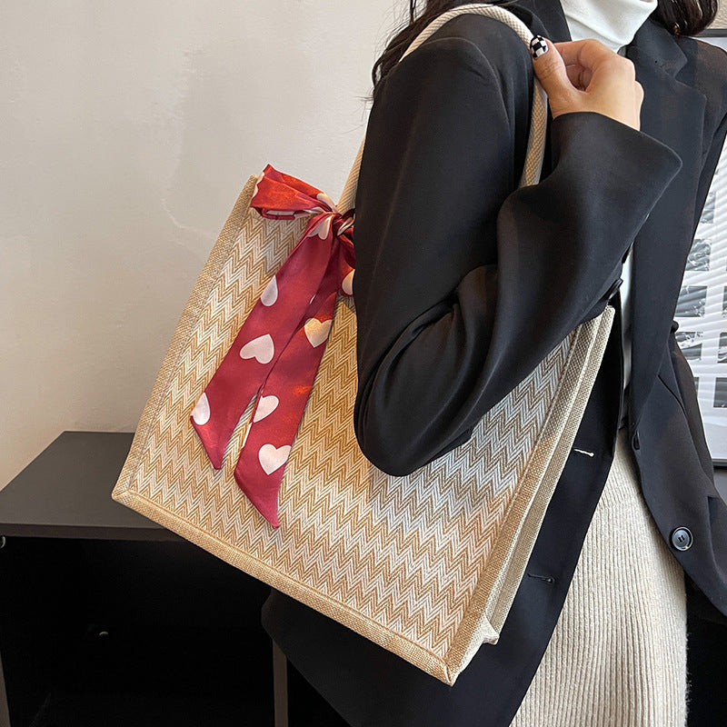 Textured Handbag with Decorative Bow