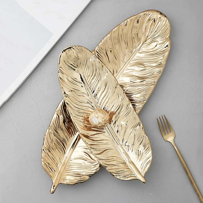 Leaf-shaped decorative tray made of metal with a textured surface