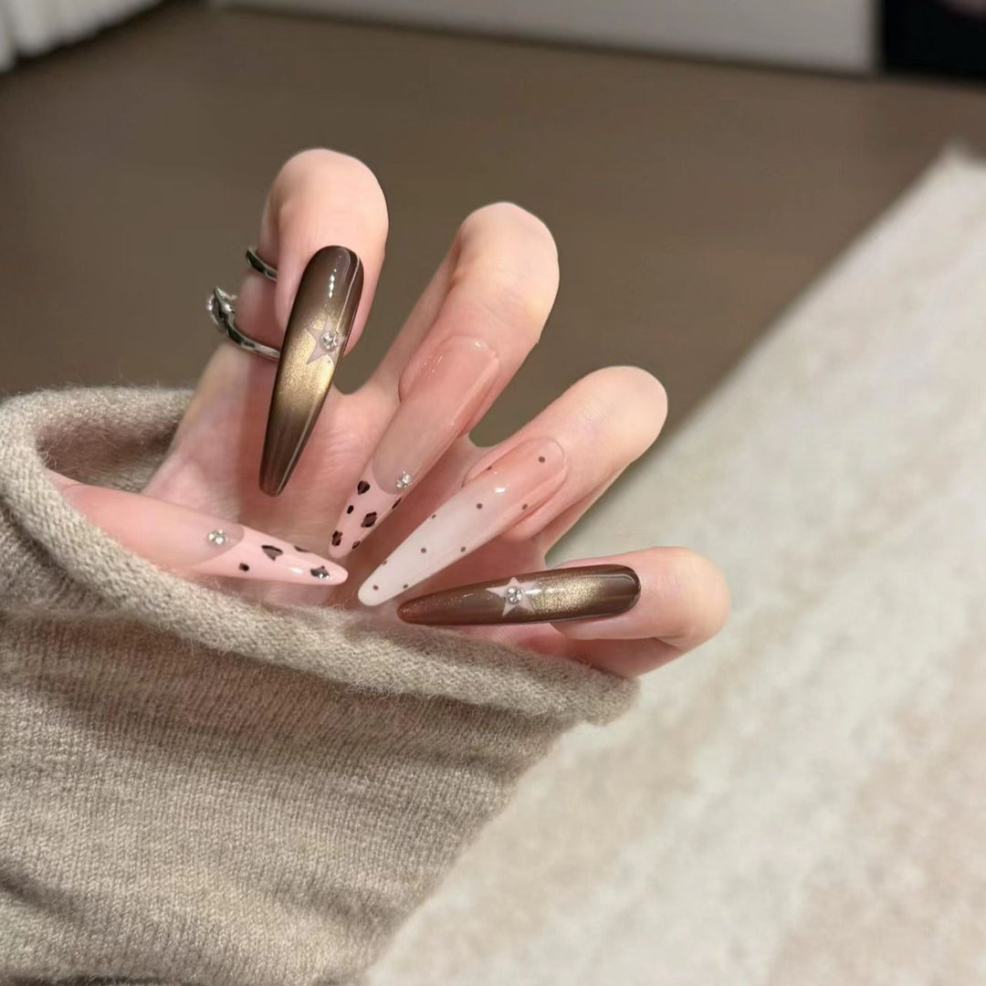 Artistic Stiletto Nail Extensions with Patterned Designs
