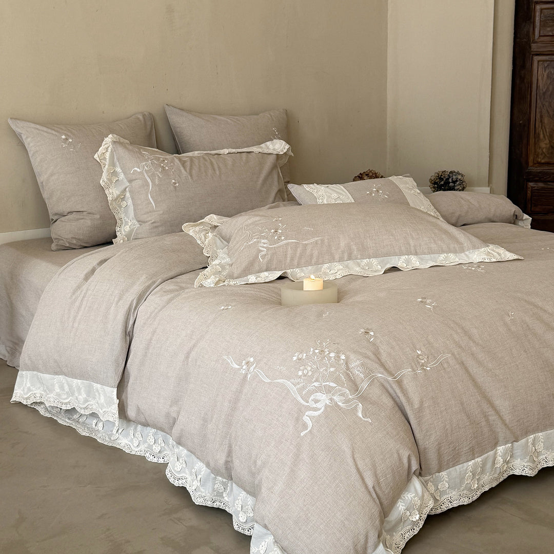 Vintage-inspired linen-cotton blend bedding set with floral chain stitch embroidery and lace trim