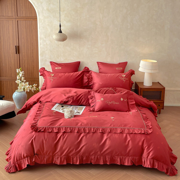 Romantic satin bedding set with ruffles, fine floral embroidery, and reversible pillowcase