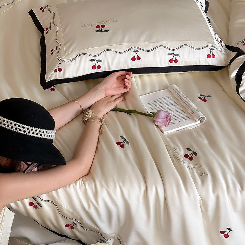 Noble satin bed linen set with cherry applique, decorative piping and frill