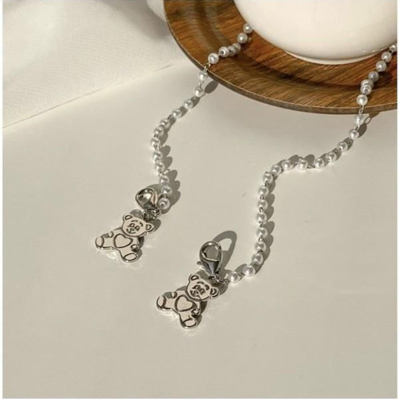 Playful pearl necklace with gold pendants Kalsten