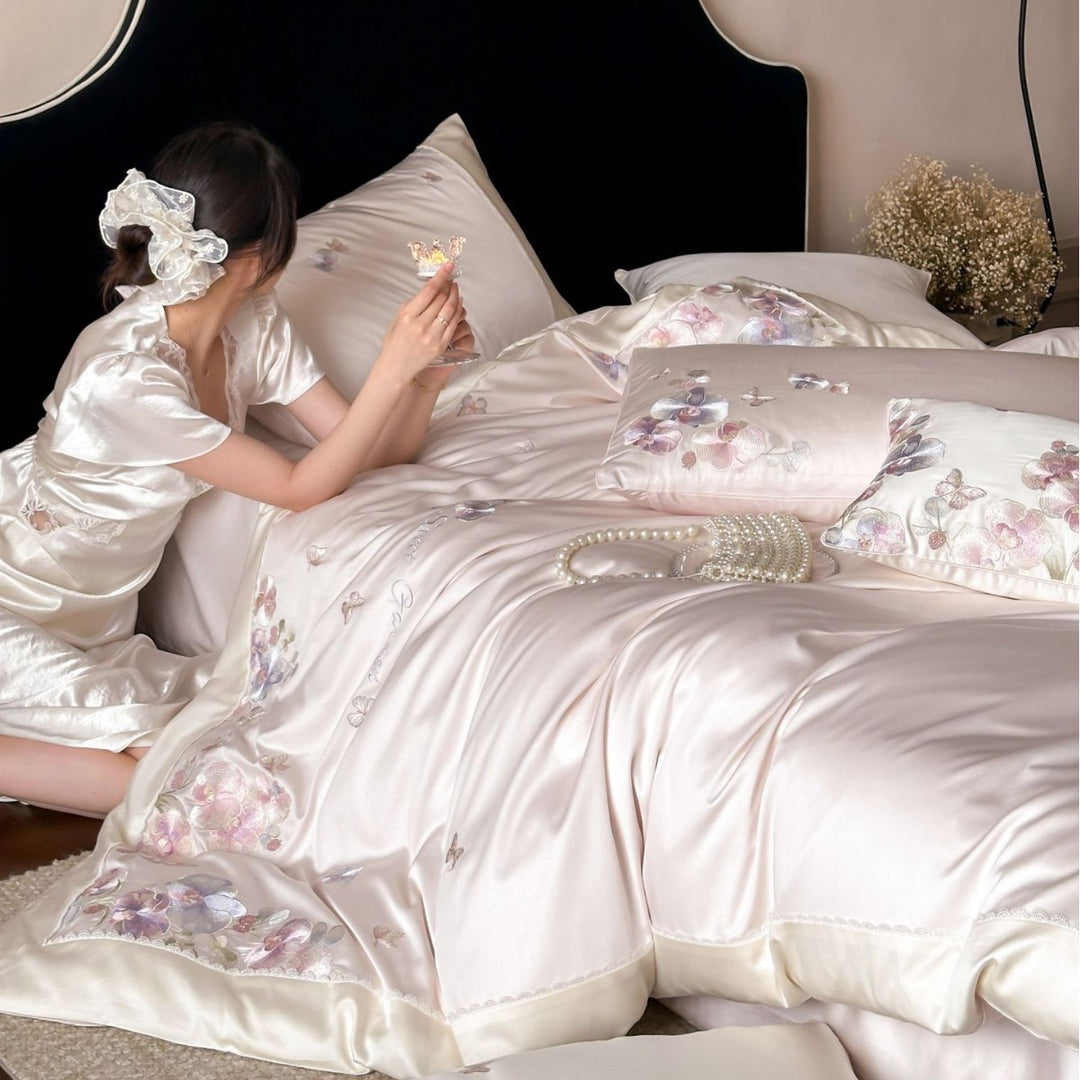 Luxurious satin bedding set with floral embroidery and butterfly appliqué