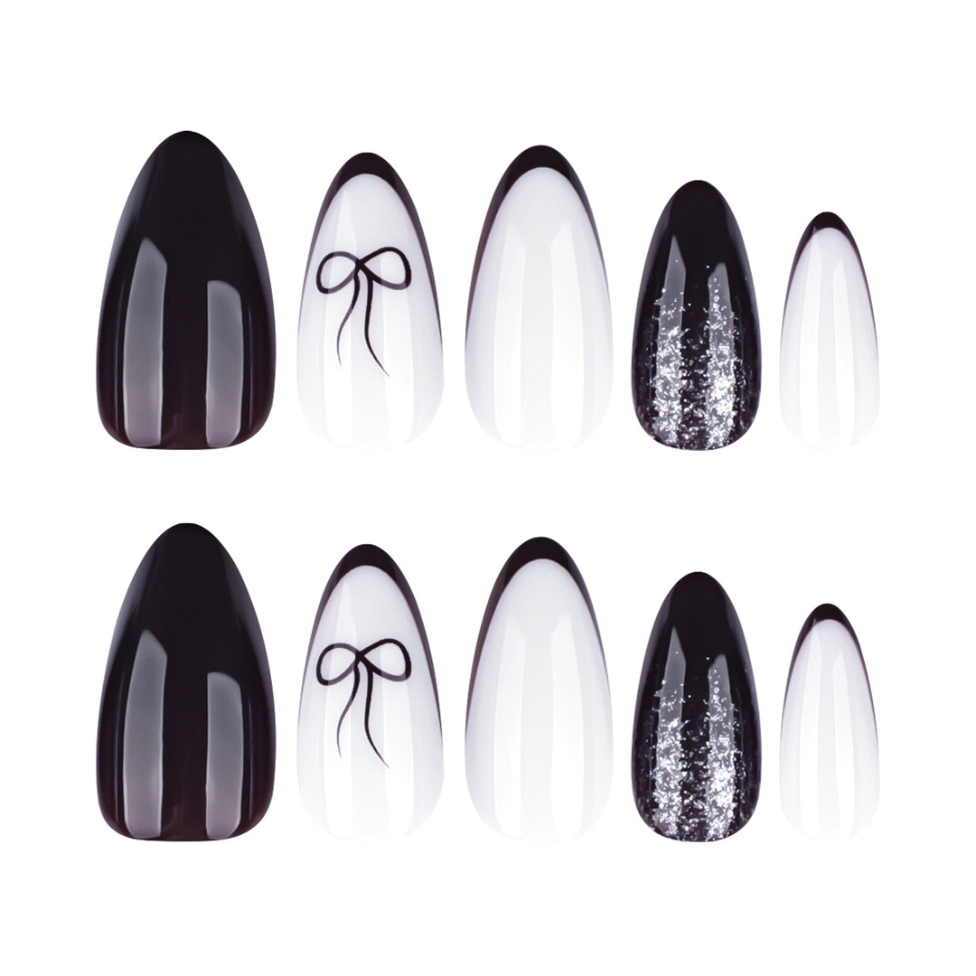 Artful nail art with elegant bow pattern and glitter accents Kalsten
