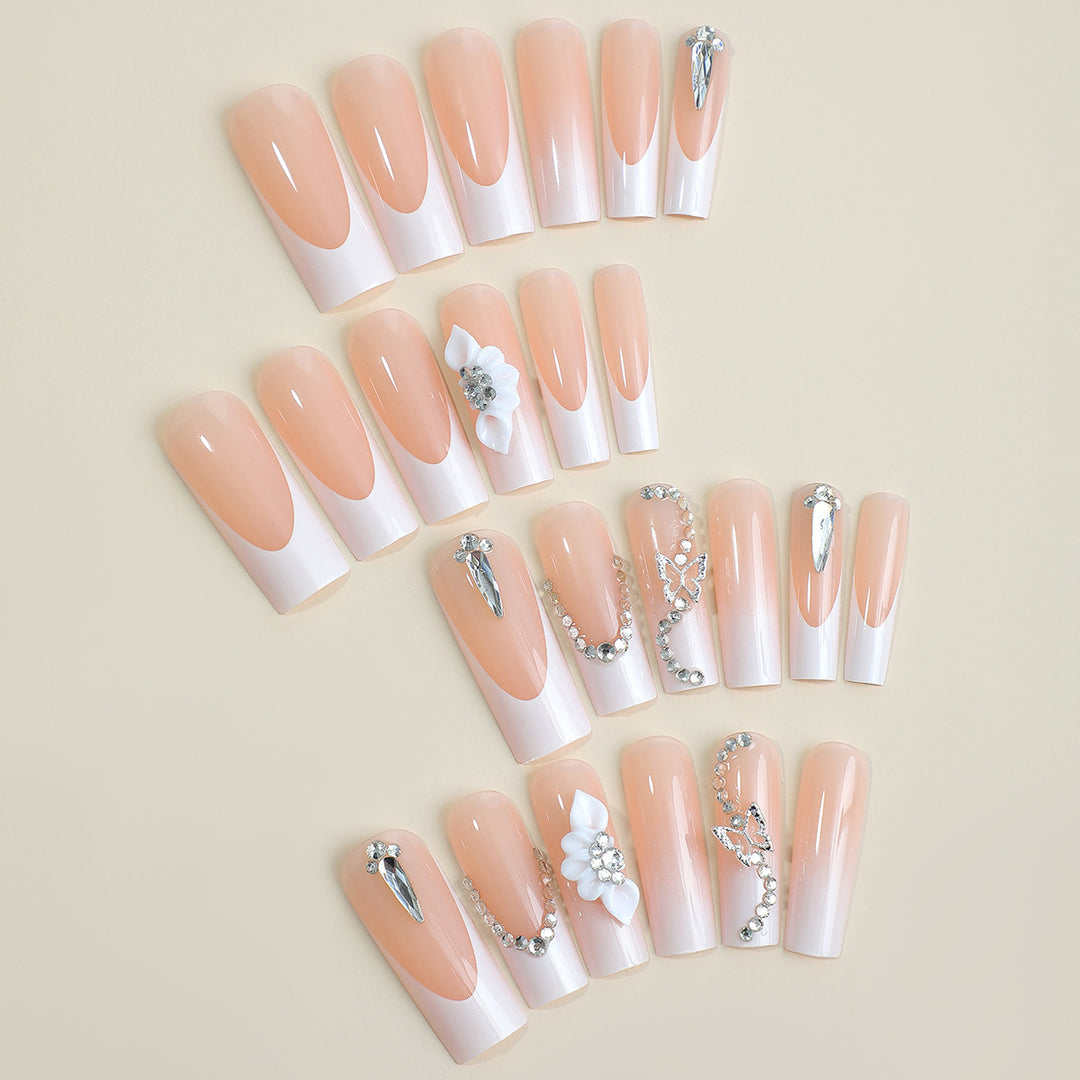 Artificial nail set with elegant French tips and glamorous embellishments Kalsten