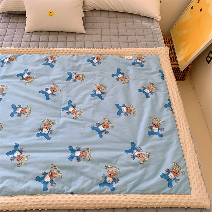 Children's quilt with colorful dinosaur print and soft minky border