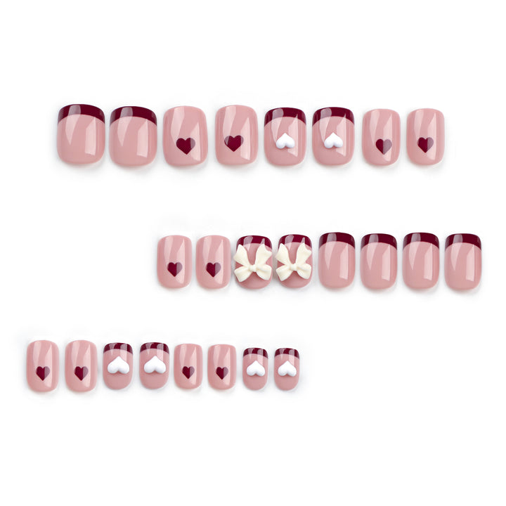 Artful nail art with heart and bow motifs Kalsten