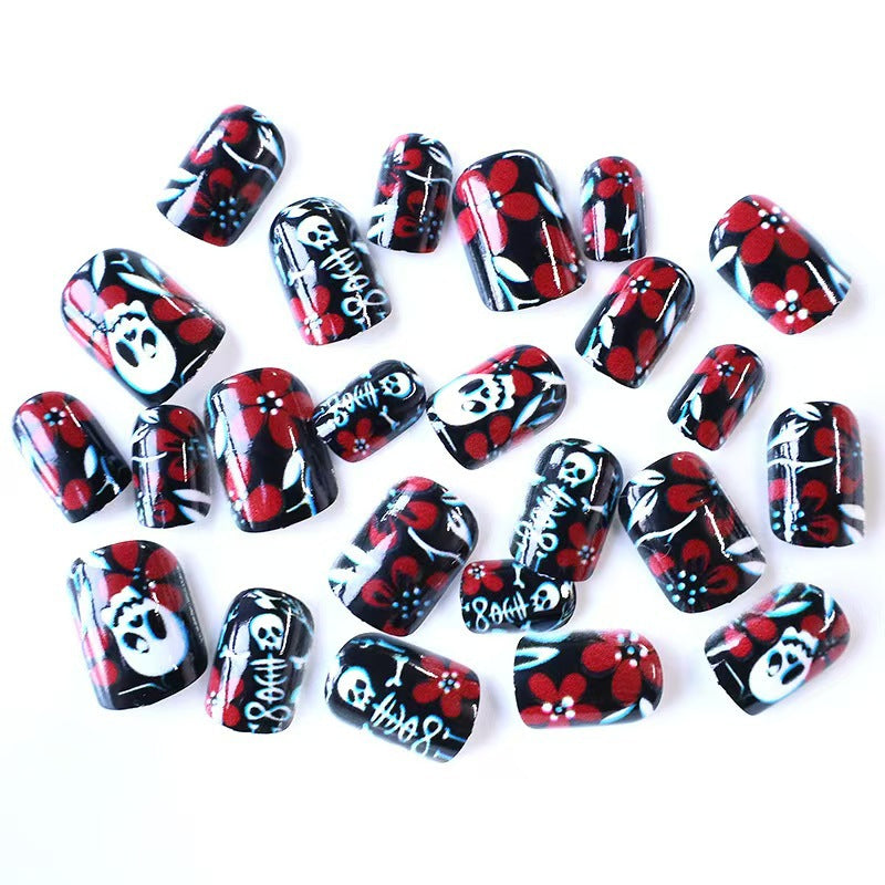 Creative nail art with skull motif and floral elements Kalsten